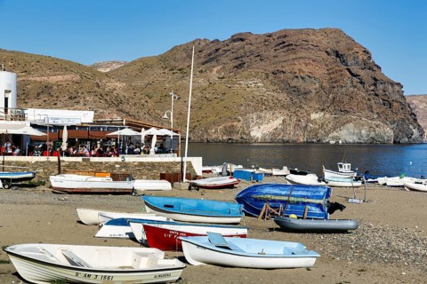 Playa de las Negras, numerous small fishing boats, distinctive Cerro Negro, mountain of dark