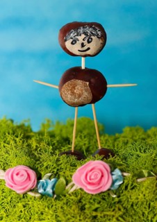 Chestnut figure standing on Iceland moss with pink decorative roses, North Rhine-Westphalia,