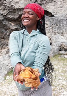 Mauritian woman, 35 years old, showing samoussas or fried dumplings, Rodrigues Island, Mauritius