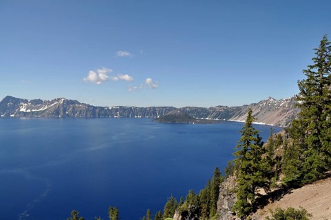 Crater Lake with deep blue water surrounded by mountain peaks under clear skies, Crater Lake