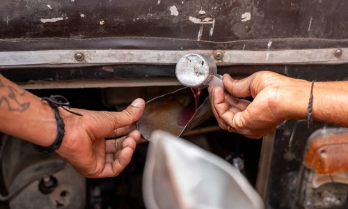 A fuel station attendant refuels a auto rickshaw at a petrol pump in Guwahati, India, on March 11,