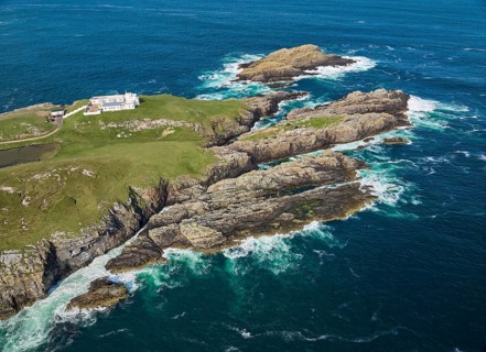 Aerial drone photo of Iighthouse on the rocky cliffs and heavy atlantic ocean surf, Strathy point,