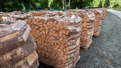 Large piles of firewood covered with nets, birch wood, Otta, Sel Municipality, Upper Gudbrandsdal,