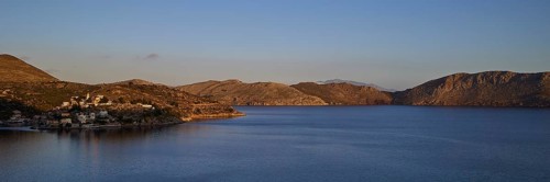 Wide sea area with coastline in morning sunlight, Symi town, Symi, Dodecanese, Greek Islands,