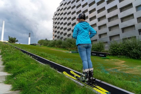 CopenHill, waste incineration plant and artificial ski slope, skiing with a view of the ski lift,