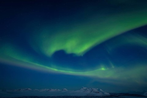 Northern Lights (Aurora borealis) over peaks in Sarek National Park and the Acre Massif, Stora