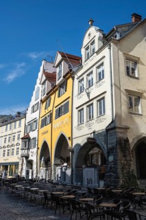 Colourful row of houses, historic town houses, residential buildings with arched arcades on