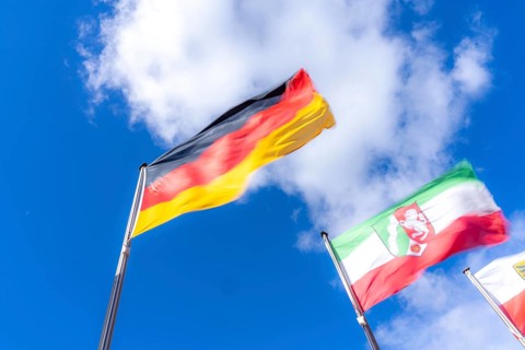 Waving Germany flag, state flag of North Rhine-Westphalia
