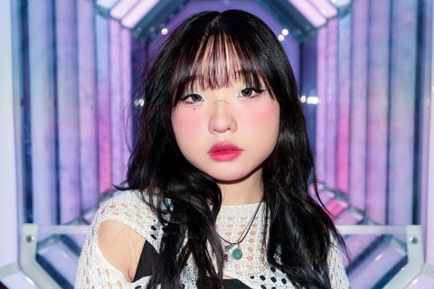 An Asian Gen Z girl enjoys the colorful ambiance of an arcade, highlighting the vibrant, modern
