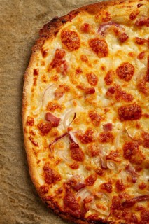 Tart flambe, open pie, rectangular pizza, with cheese and red onion, bacon slices, Alsatian dish,