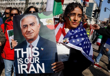 An Iranian woman wears a picture of Prince Reza Pahlavi with the inscription This is our Iran