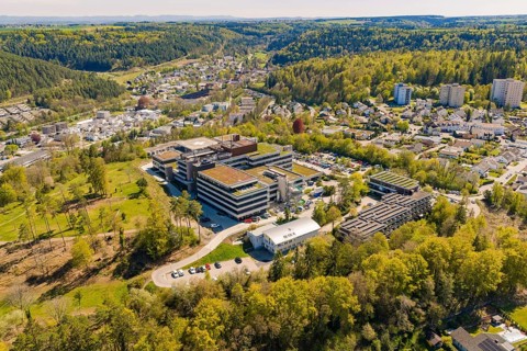 Modern hospital complex nestled in green countryside, surrounded by a small town, Nagold Hospital