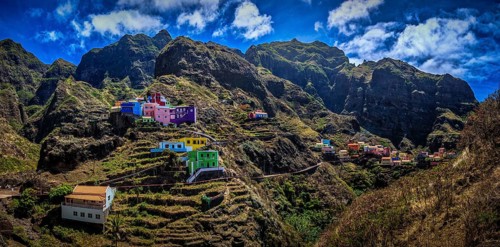 Panoramic view, small settlement, colorful village, picturesque nestled in raw, dramatic mountains