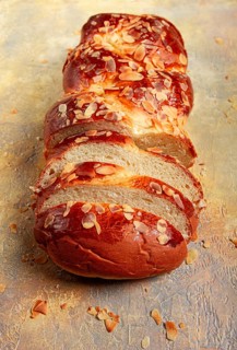 Braided, sweet bread pie, with sliced almonds, breakfast, braided bread, brioche, on a light