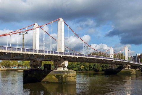 Chelsea Bridge, a 1937 self-anchored suspension bridge, spans the River Thames between Chelsea and
