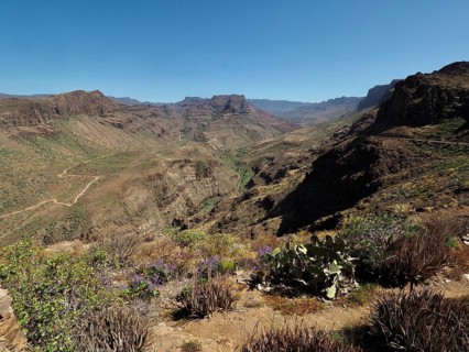 Dry valley between rocky hills under clear skies, Barranco de Fataga, Gran Canaria, Spain