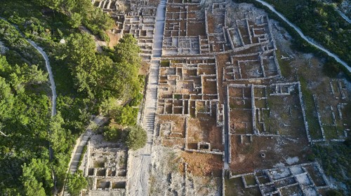 Drone shot, first morning light, Close aerial view of an ancient ruins site, clearly visible walls