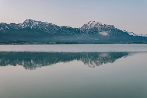 Frosty morning atmosphere during sunrise at Lake Hopfensee in the Allgäu in Bavaria, Germany