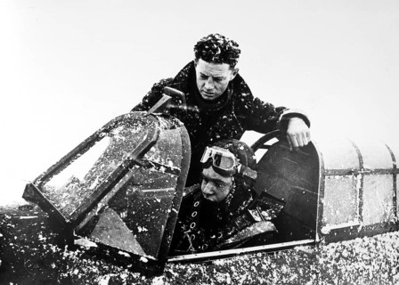 A British pilot explains the cockpit of a Hurricane to his Soviet colleague, the standard British