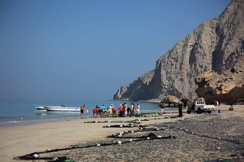 Fishermen in the coastal landscape of Bukha on the Arabian Gulf, in the Omani enclave of Musandam,