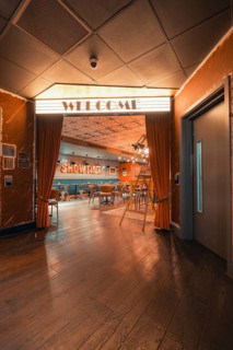 Retro entrance hall with cinema theme, curtains and warm lighting for an inviting atmosphere, Ibis
