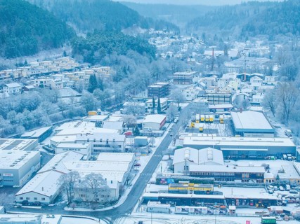 Snowy town from the air with fog-filled hills in the background, quiet winter atmosphere, Nagold,