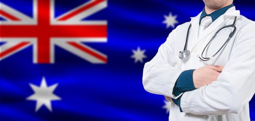 Australian Health and Care concept. Professional doctor on Australia flag. Doctor with crossed arms