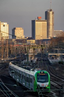 S-Bahn train on the tracks west of Essen main station, skyline of the city centre, North