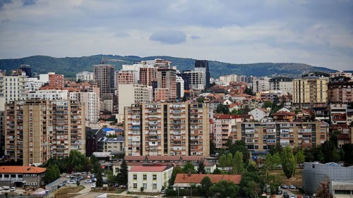 Panorama of a city with densely built residential buildings and a cloudy sky, Pristina, Kosovo