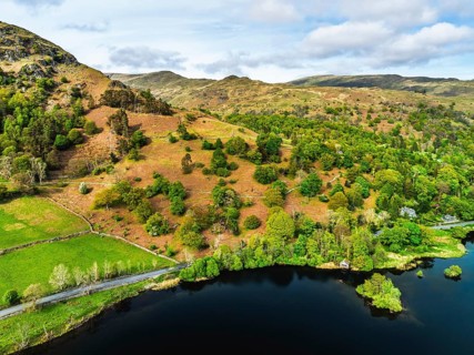 Farms and Mountains over road A591 from a drone, Grasmere Lake, Grasmere, Ambleside, Lake District,