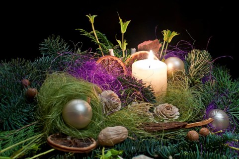 Christmas floral decoration with candle.