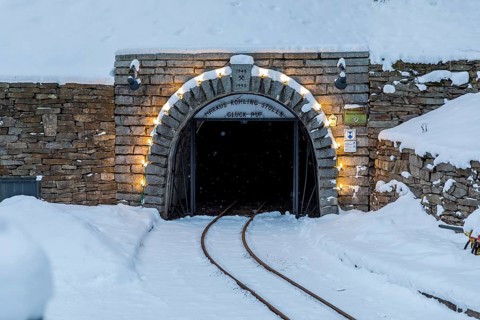 Illuminated mouth hole from the Markus-Röhling-Stolln visitor mine in the snow, template for a