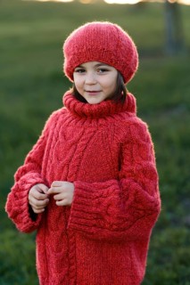 A young girl in a vibrant red knitted hat and sweater enjoying a sunny Autumn day at a park, her