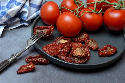 Fresh and dried tomatoes on a plate, Solanum lycopersicum