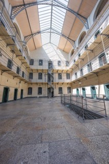 Large courtyard with glass roof and surrounding galleries in a historic building, Kilmainham Gaol