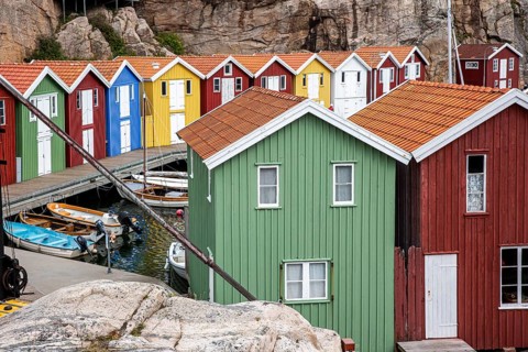 Small colourful houses by the sea. Typical houses in Sweden for the coastal landscape. Crab fishing