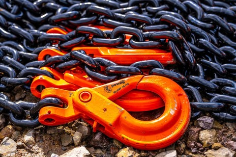 Heavy, thick chains made of steel, black chain links, orange painted hooks, Germany