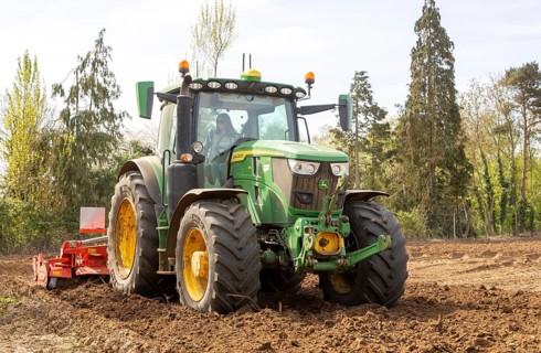 John Deere 6R 185 mid-size tractor with Kuhn HR power harrow for intensive seedbed preparation.