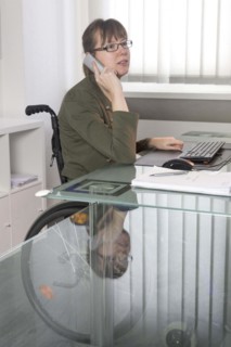 Young woman in a wheelchair at her workplace, Berlin, 18/01/2017
