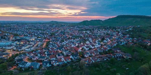Expansive city view at dusk with scattered houses against a dramatic sky, Korb im Rems Valley,