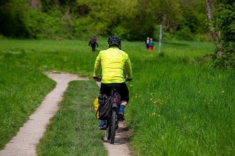 Neckartal-Odenwald nature park Park: Cyclists travelling between forests and meadows on the Neckar