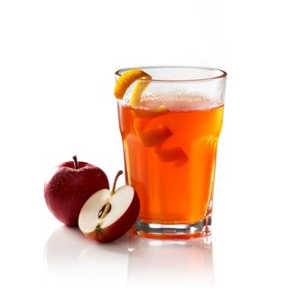 Hot apple punch on a white background, apple, half of apple and orange zest as garnish, studio shot