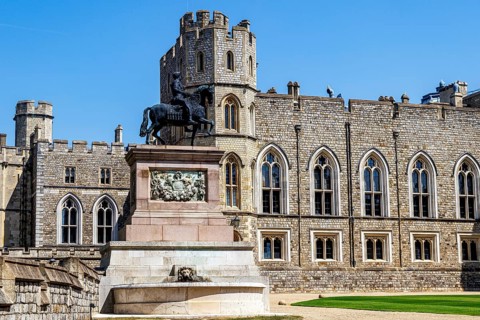 A bronze equestrian statue of King Charles II stands before the Round Tower in the Quadrangle, cast