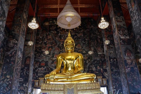 Bangkok, Thailand. February 20th 2025. Beautiful view of gilded Buddha statue among amazing murals