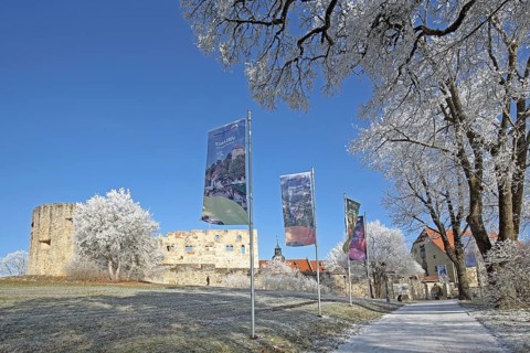 Path with flags in winter with snow and hoarfrost to Hellenstein Castle, Heidenheim an der Brenz,