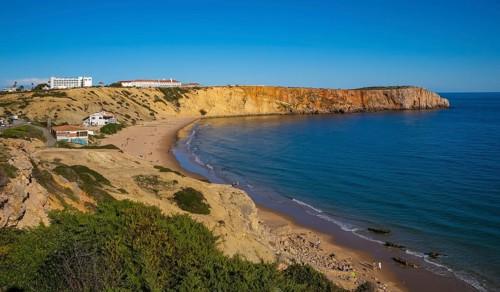 Sagres, Algarve, Portugal - Praia da Mareta town beach, Ponta da Atalaia viewpoint at the back