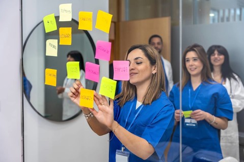Medical professional team collaborating in a hospital or medical center, organizing concepts on a