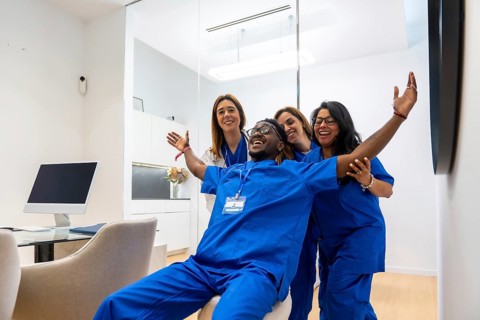 Diverse group of healthcare professionals celebrating a victory or breakthrough in a contemporary