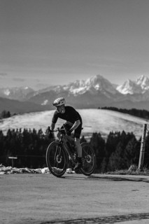 Road bike rider in spring near Halblech in the Allgäu in front of a picturesque backdrop of the
