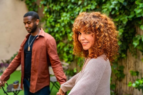 Smiling woman looking back while holding hands with a man, symbolizing human connection, support,
